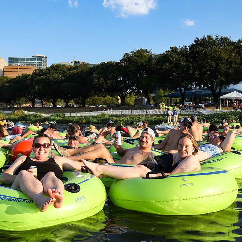 people hanging out in intertubes on the river
